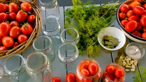 Tomatoes, Jars, and Spices on Wooden Table