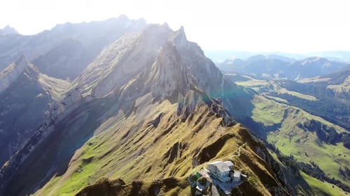 Aerial flyover over Schaefler ridge in Appenzell, Switzerland with view of Alpstein peaks in dayligh