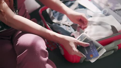 Young Adult Packing Suitcase for Trip