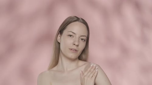 Body Cream A Young Halfnaked Woman Applies Cream to Her Shoulders Woman with Cream in Her Hands in