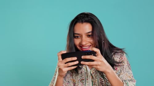 Gamer Enjoying Game on Mobile Phone Having Fun