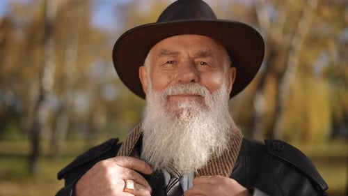 Smiling Senior Man with White Beard Outdoors