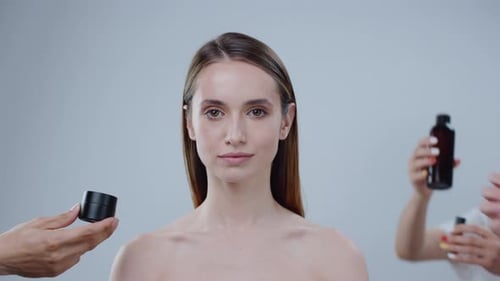 Woman with Flawless Skin surrounded by Skincare Products