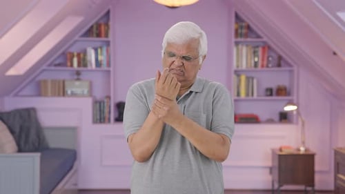 Man Experiencing Arm Pain in Lavender Room