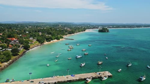 Aerial View Azure Lagoon Dotted with Fishing Boats Near Tropical Coast Footage Shows Vessel Movement