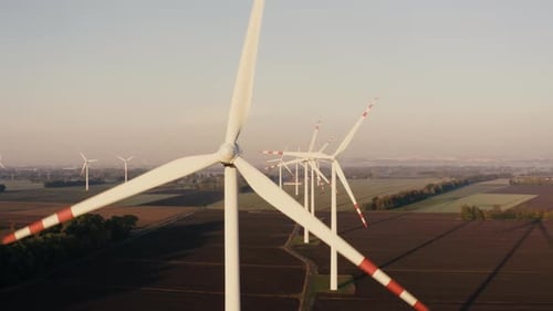 Aerial View of the Wind Turbine Farm on a Beautiful Orange Sunrise
