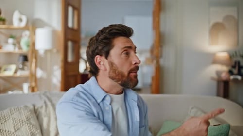 Exasperated Man Talking on Phone as Children Play