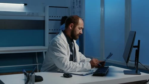 Doctor Analyzing X-Ray in Dark Medical Office