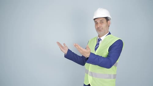 Engineer looking at camera in amazement and making a presentation.