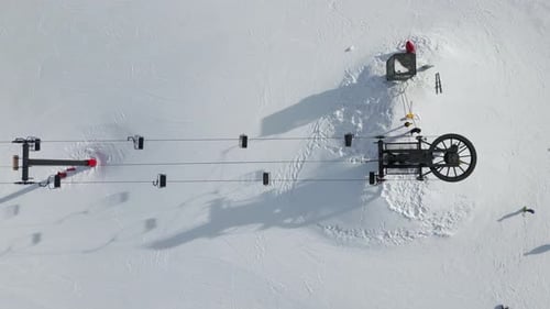 Ski Lift with Chairlifts Operating on Snowy Mountain Slope at Ski Resort in Brian Head, Utah