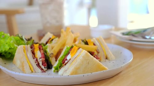 Club Sandwich and French Fries on White Plate in Cafe
