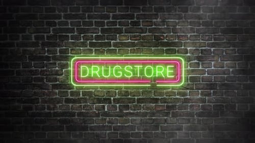 Drugstore neon signboard on bricks wall background. Luminous sign with green and pink neon colors.