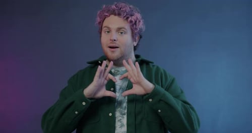 Young Adult Gesturing with Hands on Blue