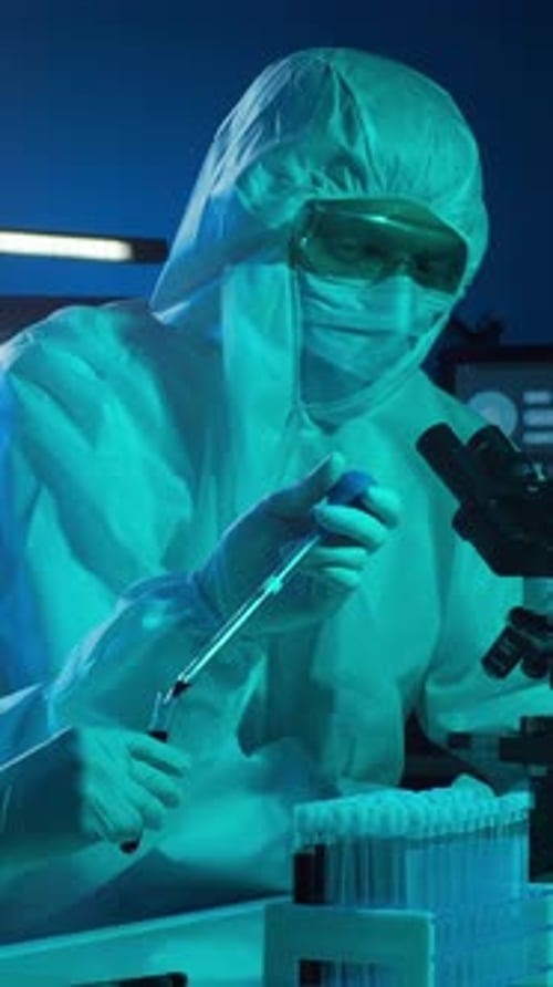 Scientist in Protective Suit Analyzing Blood Samples