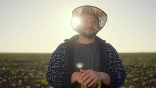 Portrait of Joyful Farm Worker with Straw Hat on Head in Agricultural Fields Smiling Caucasian