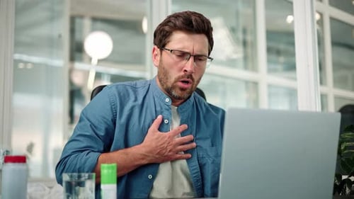 Closeup of Working Bearded Man in Glasses Difficulty Breathing or Chest Pain