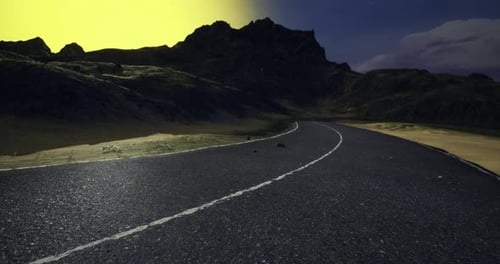 Winding Road Surrounded By Mountains at Sunset Near a Tranquil Valley