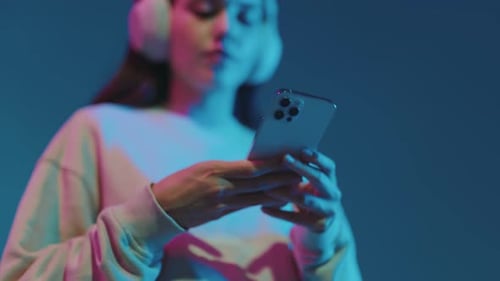 Woman Using Smartphone with Headphones On