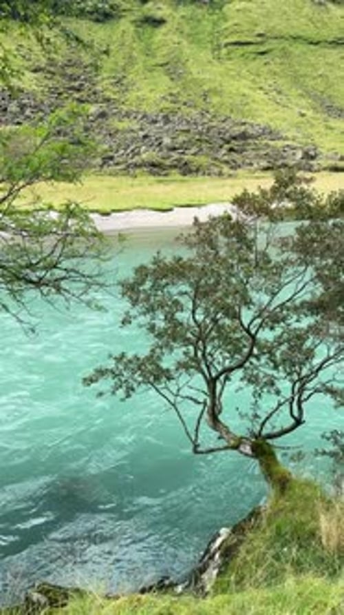 Scenic Turquoise Glacial River Flowing Through Mountain Valley