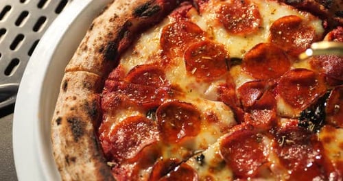 Delicious Pepperoni Pizza Topped with Basil and Oil