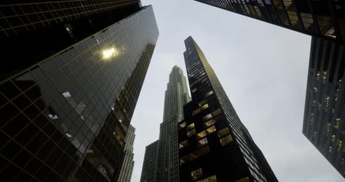 View of Towering Skyscrapers Under a Cloudy Sky in an Urban Area