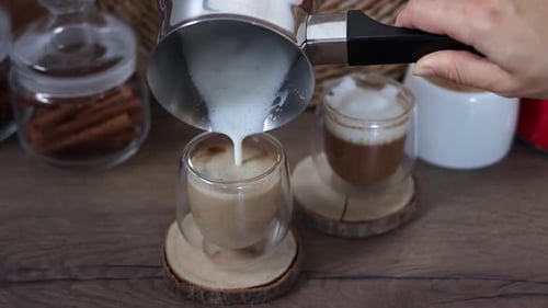 Milk Being Poured Into Coffee Glass