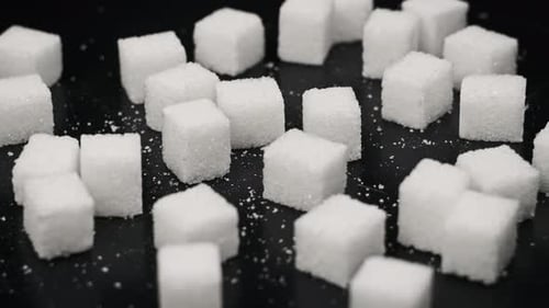 Sugar Cubes Rotate on the Table CloseUp