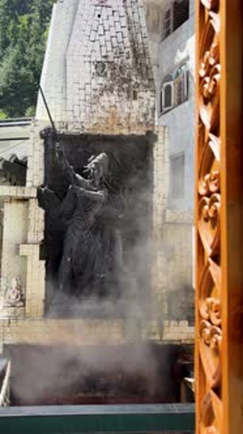 mystical shiva idol with trishul amid hot steam temple backdrop and spiritual ambiance at manikaran
