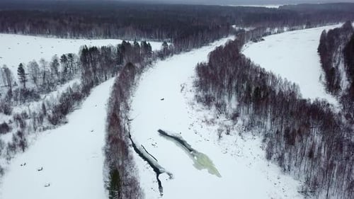 A Beautiful Aerial View of a SnowCovered River Within a Picturesque Winter Landscape Stock Clip