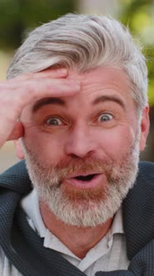 Surprised Man with Gray Hair Reacts with Delight