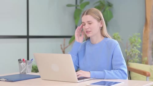 Tired Woman Working on Laptop in Office