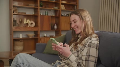 Woman Relaxing at Home, Interacting with Phone