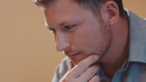 A Man's Face Plan Uses a Laptop Look at the Screen In Reflection Pondered Portrait Technology Blue