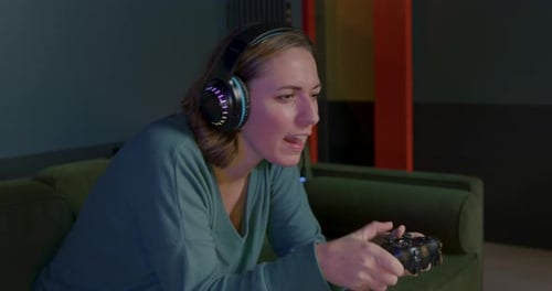Woman Playing Video Game With Colorful Headphones