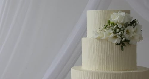 Elegant Wedding Cake with Cream Icing and Flowers