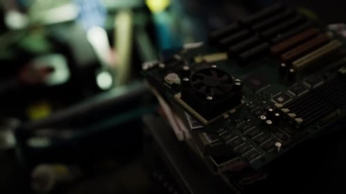 Close Up View of a Circuit Board with Components in a Dimly Lit Workshop