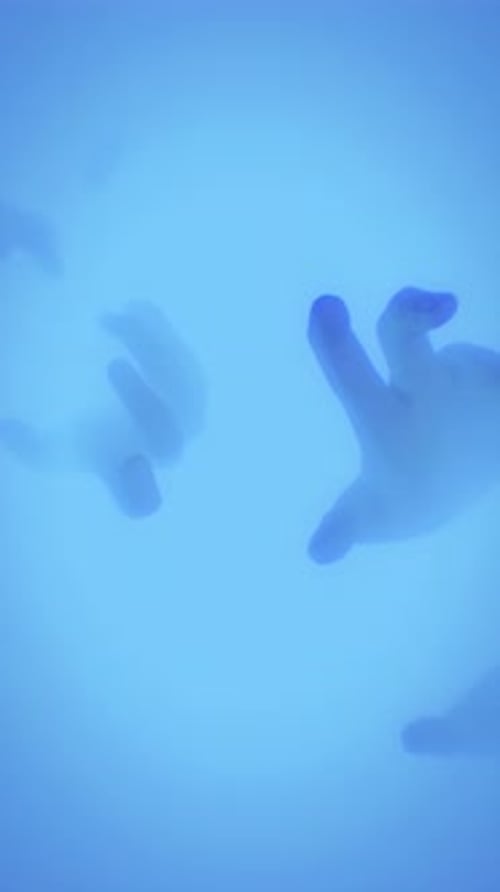 Abstract Fluid Hand Shapes Moving in Blue Haze