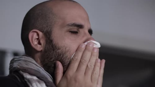 Ill Man Blowing Nose into Tissue Close Up
