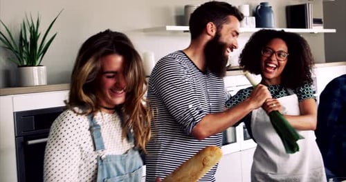 Friends Cooking and Laughing in Modern Kitchen