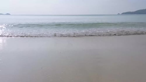 Summer video 4k of the beach with some waves in sunshine daytime with white sand beach and clear blu