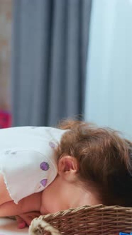 Happy toddler playing with modeling clay on table