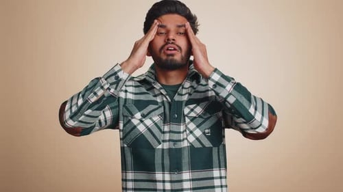 Young Man Massaging Temples, Suffering Headache