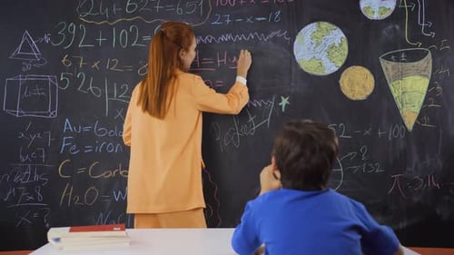 Teacher Explains Math Concepts to Student at School