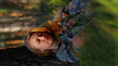 Woman Lies Down on a Log in Nature