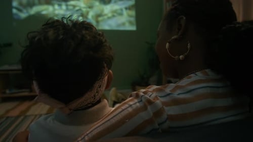 Woman and Child Watching Movie at Home