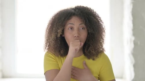 Young Woman Coughing Indoors