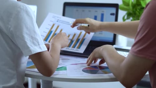 Businessman Analyzing Financial Statement And Annual Performance Graph