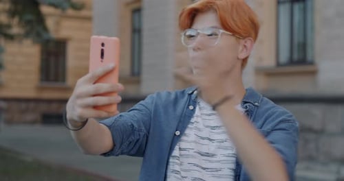 Young Adult Recording a Vlog on Smartphone