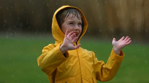 Young Boy Playing in Rain,