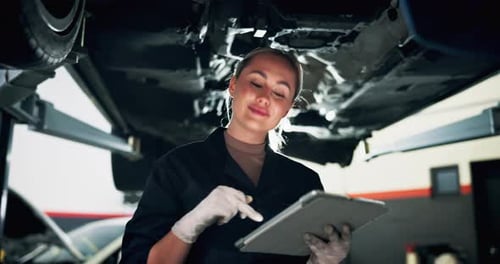Mechanic, car and woman with tablet, inspection and calibration with vehicle maintenance